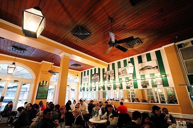 lots of people sitting inside the Cafe du Monde