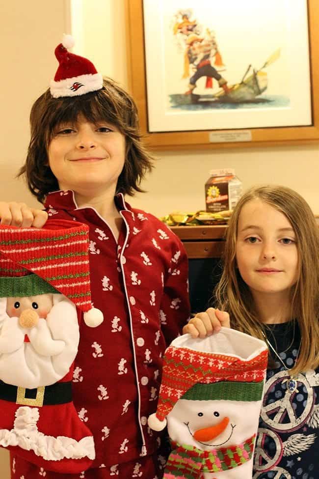 kids holding Christmas stockings