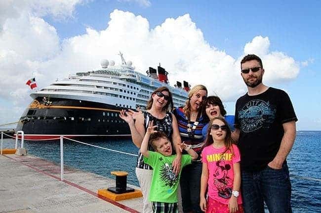 group picture during Merrytime Disney Cruise with the cruise ship at the background
