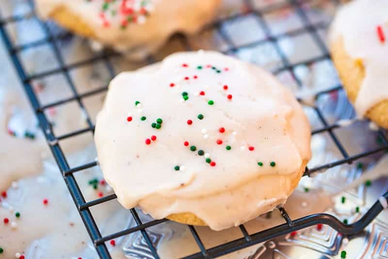 glazed Eggnog Cookies topped with Christmas sprinkles on cooling rack