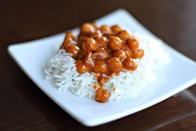 Chickpea Curry on top of rice in a white plate