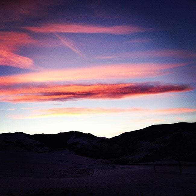 view of red blue sunset and mountain