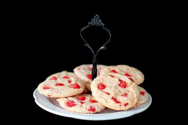 Cake Mix Cookies with Cherry in a white cake holder on dark background