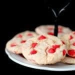 Cake Mix Cookies with Cherry in a white cake holder on dark background