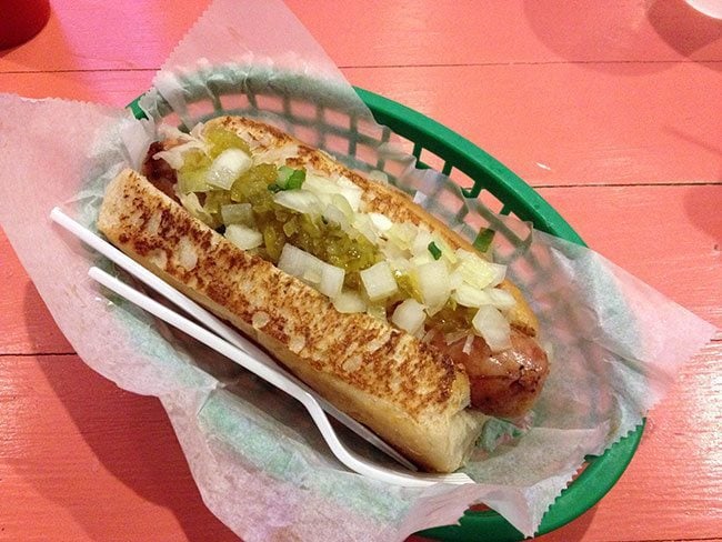 An Alligator Sausage Dog in a green tray