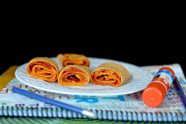 Pepperoni Pizza Rolls in White Plate Over a Notebook