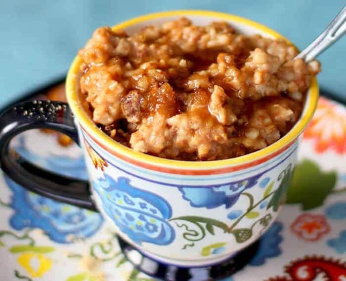 Cinnamon Raisin Slow Cooker Oatmeal topped with maple syrup