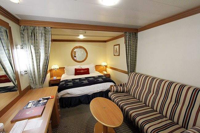 Stateroom 6083 with queen bed and sleeps three, with the pull out sofa couch
