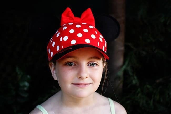young girl wearing minnie hat
