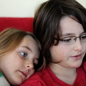 siblings sitting beside each other