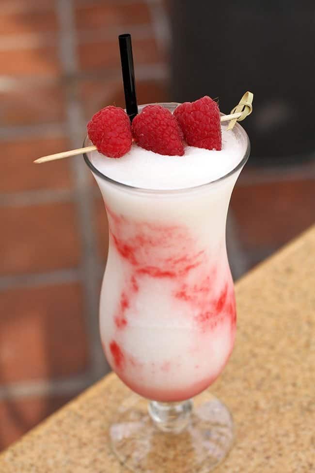 A Glass of Strawberry Pina Colada topped with Three Fresh Strawberries