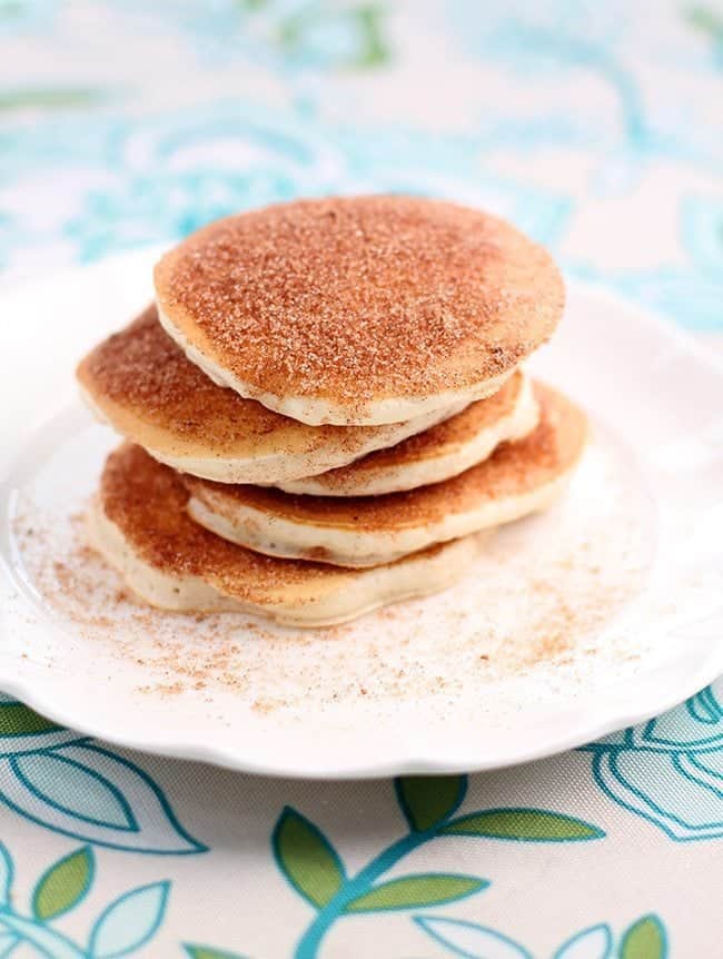 Top down shot of Snickerdoodle Pancakes coated with sugar and cinnamon mixture in a white plate