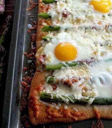 Breakfast Pizza with Asparagus, Capicollo and Eggs sprinkled with Cheese