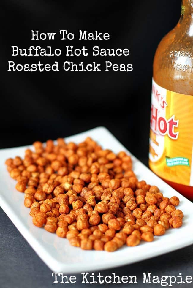 Roasted Chickpeas in a white rectangular plate and a bottle of Buffalo Hot Sauce