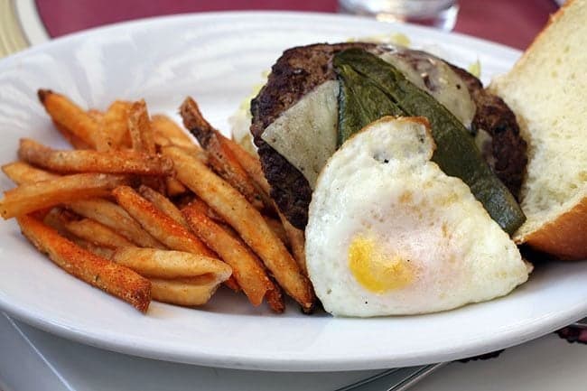 Angus chuck patty, manchego cheese, roasted poblano chile, tomato, lettuce, fried egg, and house sauce on toasted brioche.