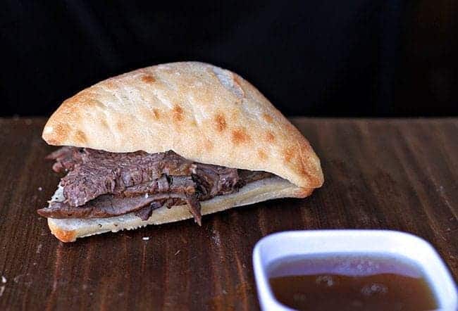 Crock Pot Beef Sandwiches and Dip Sauce on wood background