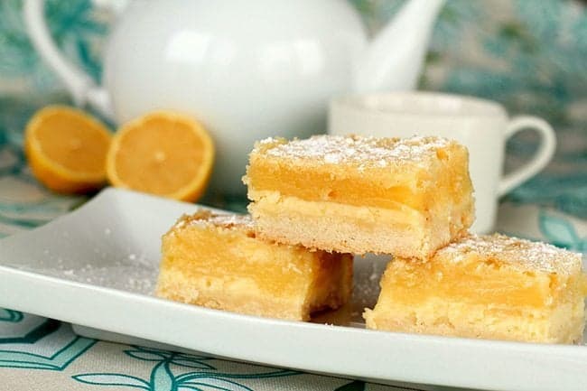 Three Pieces Lemon Cheesecake Bars in White Plate