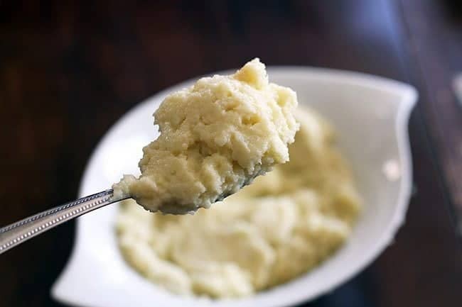 A spoon of Creamy and Cheesy Mashed Cauliflower