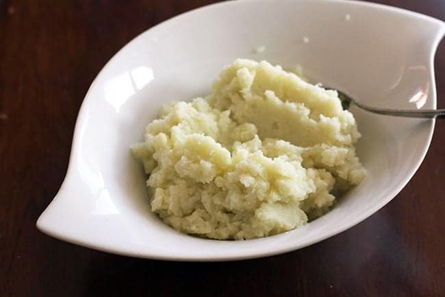 Mashed Steamed Cauliflower in a white bowl