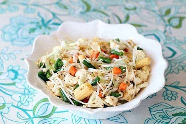 close up Marinated Vegetable Salad in a white ruffle bowl