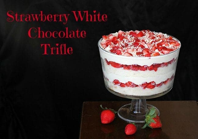 A glass filled with strawberry white chocolate trifle