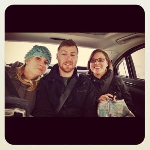 three siblings sitting at the back of the car
