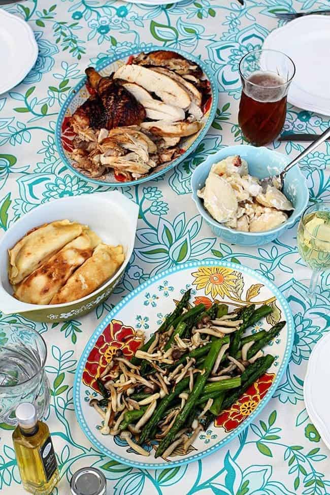 Roasted chicken, beer, perogies and cottage cheese crud filled crepes with dill in the table along with roasted asparagus and beech mushrooms