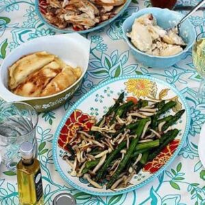 Roasted chicken, beer, perogies and cottage cheese crud filled crepes with dill in the table along with roasted asparagus and beech mushrooms