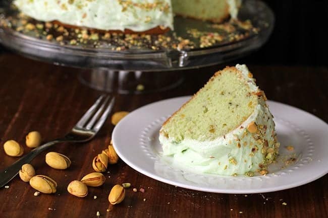 A slice of Homemade Pistachio Pudding Cake in a white plate
