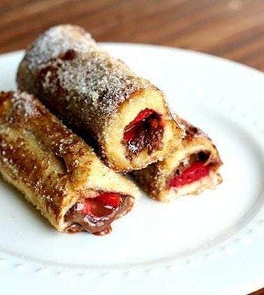 3 pieces of Strawberry Nutella French Toast Rolls in a white plate