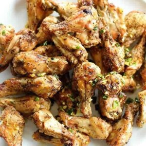 Close up of Salt and Pepper Chicken Wings with Garlic Oil Over the Top