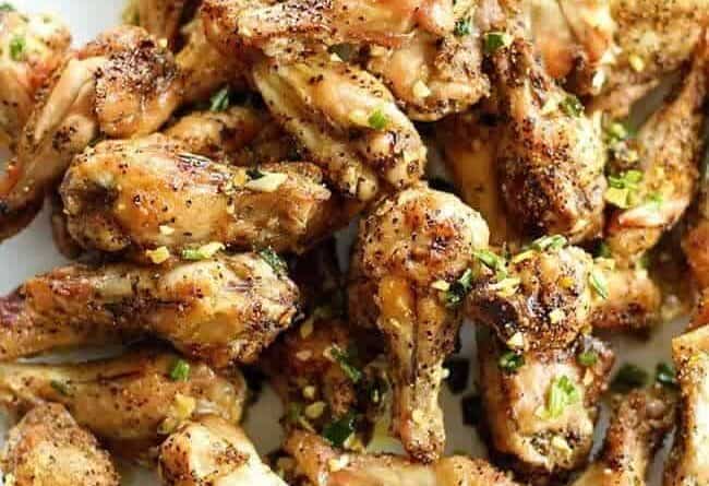 Close up of Salt and Pepper Chicken Wings with Garlic Oil Over the Top
