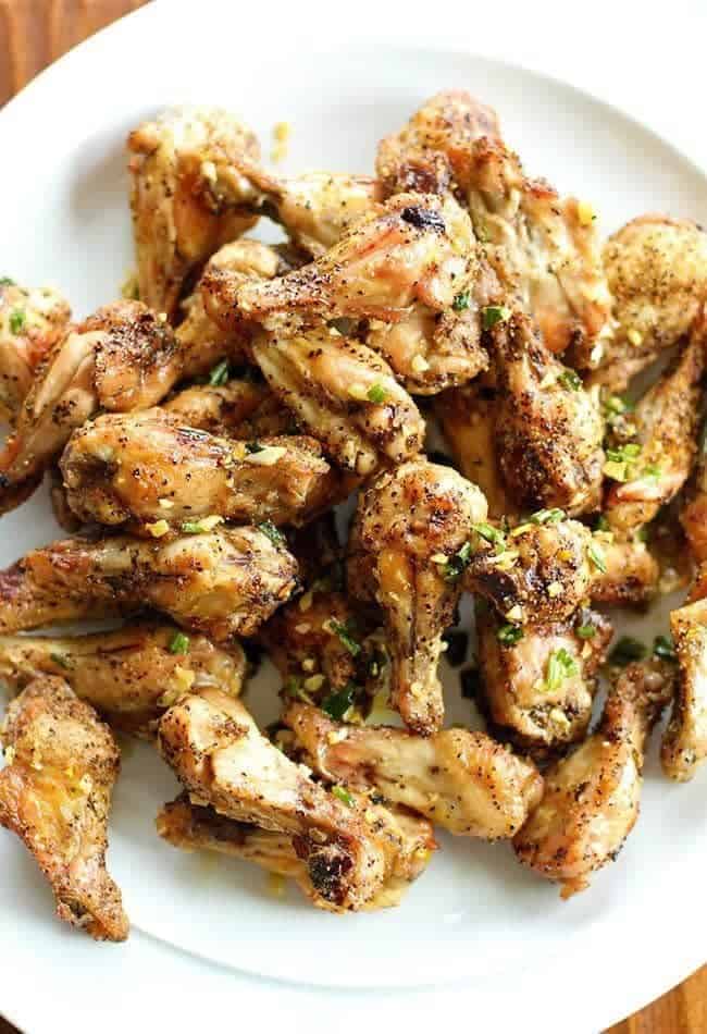 chicken wings in a white plate with salt and pepper