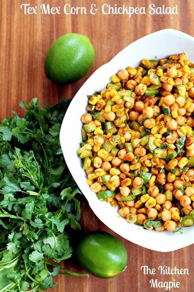 tex mex corn and chikpea salad in a white bowl garnish with parsley leaves