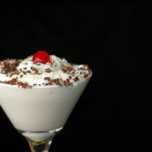 Bailey's Chocolate White Russian in martini glass with whipped cream, chocolate shaving and cherry on top