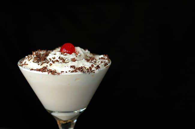 Bailey's Chocolate White Russian in martini glass with whipped cream, chocolate shaving and cherry on top