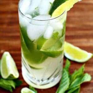 Close up of Mojito With Honey, garnish with mint leaves and lime wedges