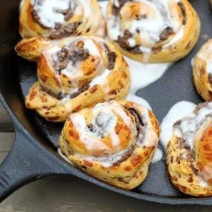 Close up Campfire Skillet Oreo Cinnamon Buns with Cream Cheese on Top