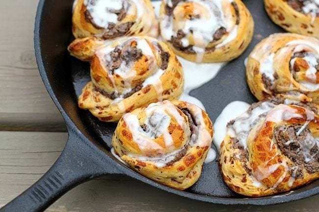 Close up Campfire Skillet Oreo Cinnamon Buns with Cream Cheese on Top