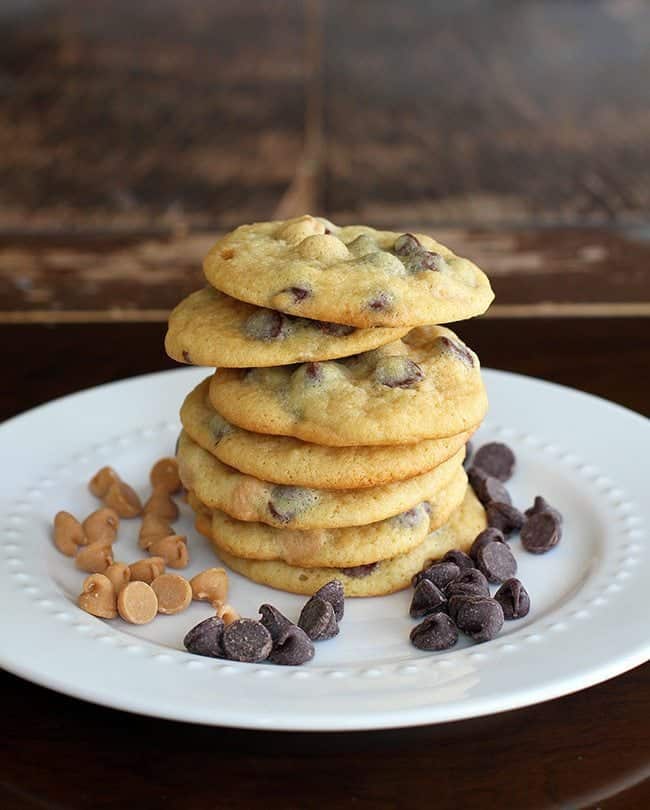 Stack of Peanut Butter and Chocolate Banana Pudding Cookies in white plate with chocolate chips