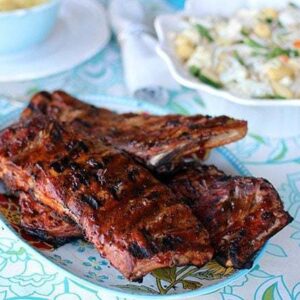 Amazing BBQ Ribs in a plate on a table with blue floral tablecloth