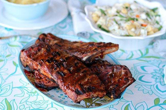 Amazing BBQ Ribs in a plate on a table with blue floral tablecloth