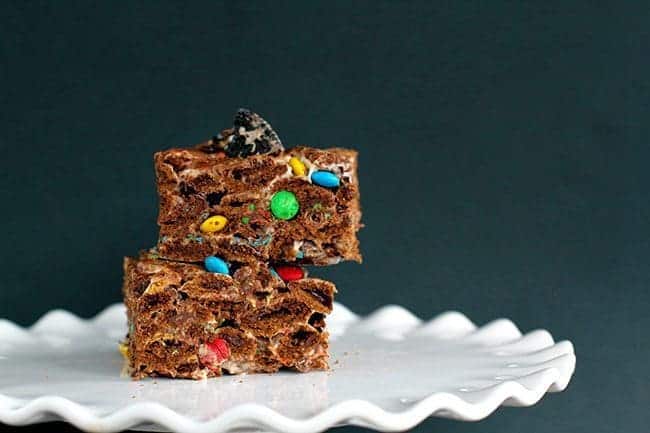 Chocolate Oreo & M&M Cereal Bars on a white cake holder