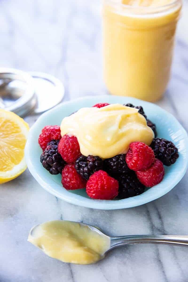 Close up of lemon curd in blue Pyrex bowl