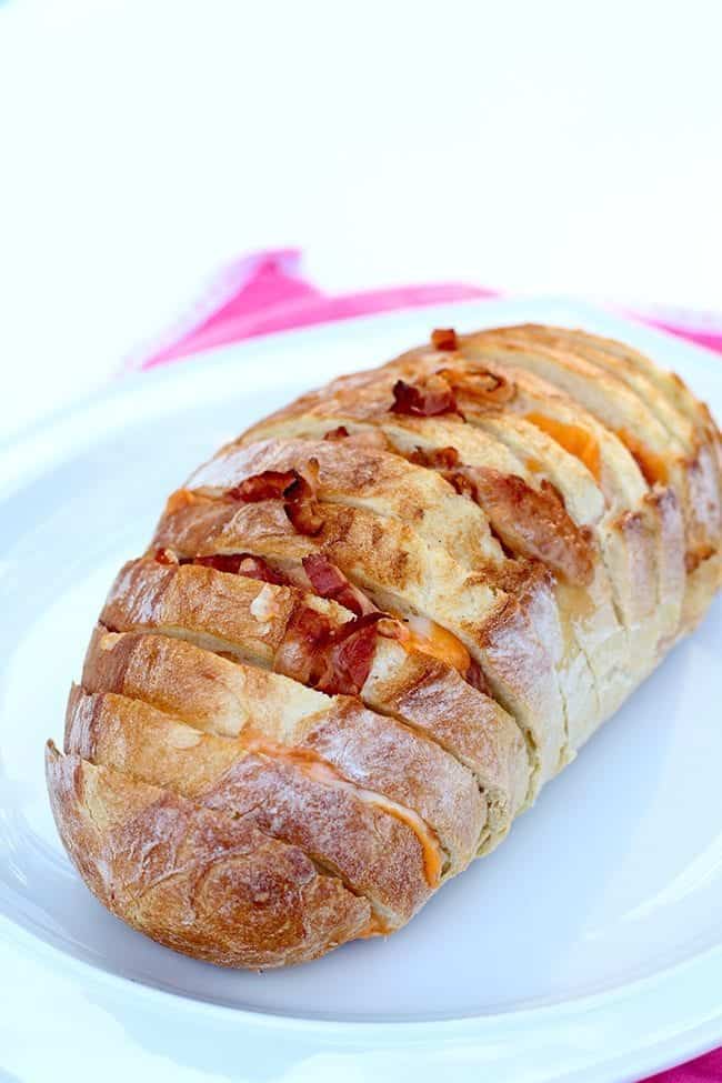 close up of Bacon & Cheese Pull Apart Loaf in a white plate