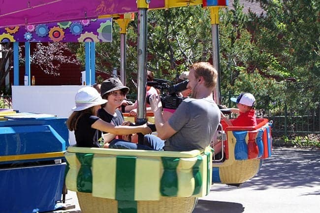 two kids riding the Samba Spin with their camera man