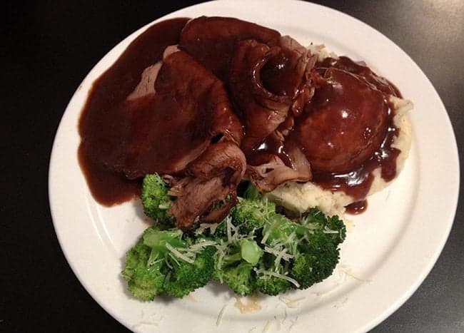roast beef with mashed potatoes and teared broccoli in a white plate