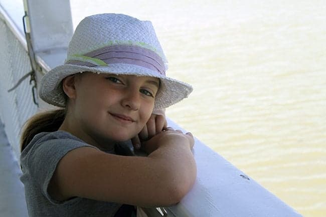 young girl enjoying the cool breeze during travel