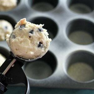 plopping the cookie dough into muffin tins