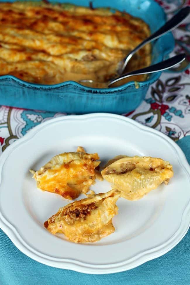 Cheesy stuffed taco shells on white plate